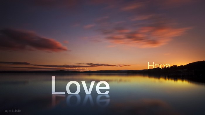 Love Peace Hope words over lake at sunset