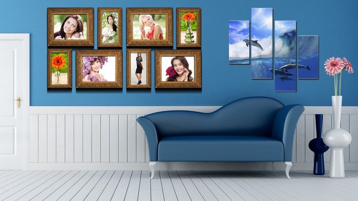 Wall art with dolphins and framed photos above a blue sofa