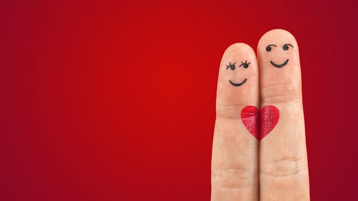Couple Fingers with Heart on Red Background