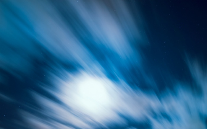Moonlight streaks across a starry night sky