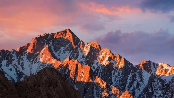 Mountains during sunset with pink and purple clouds