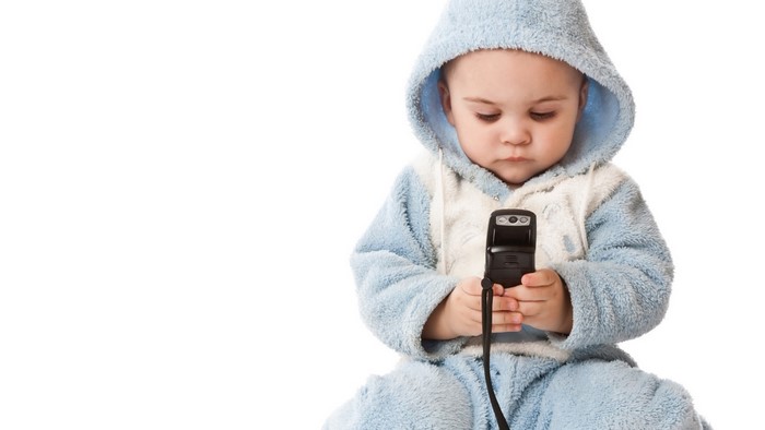 Cute Baby Boy in Blue Pajamas Holding a Mobile Phone
