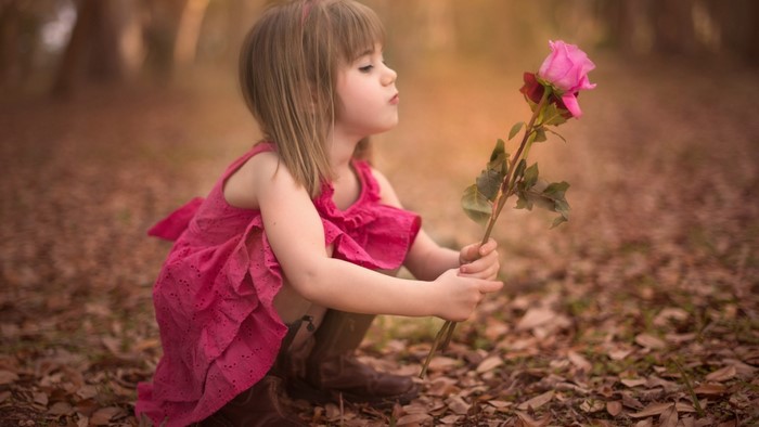Cute Little Girl with Pink Rose
