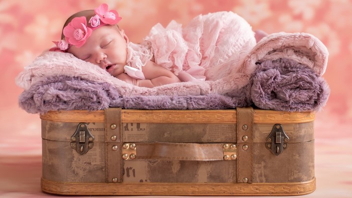 Cute Baby Sleeping on Suitcase