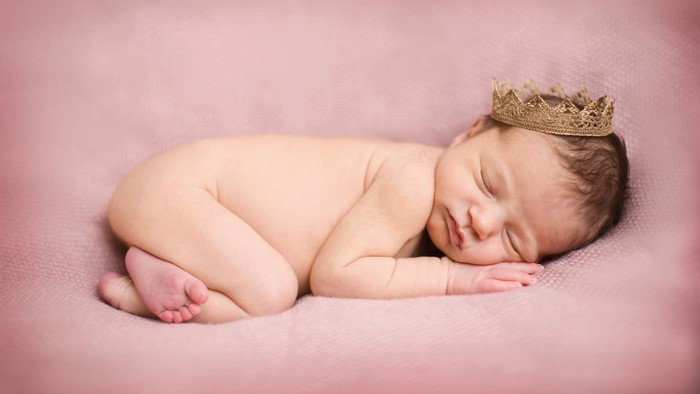 Newborn baby wearing a crown
