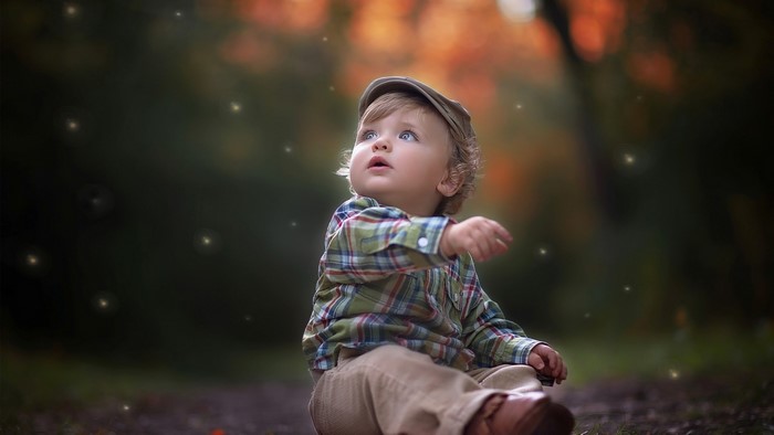 Cute Little Boy in a Plaid Shirt and Cap
