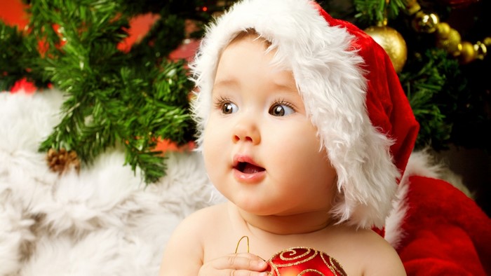 Baby in Santa Hat Holding Christmas Ornament
