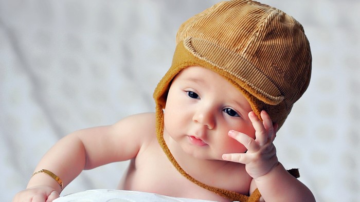 Baby boy wearing a brown corduroy hat