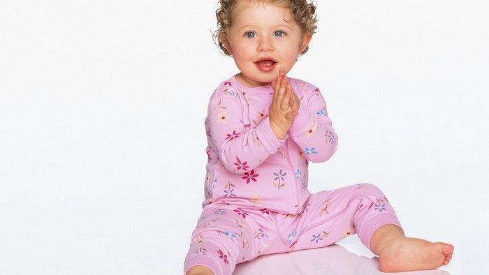 Cute baby girl in pink pajamas
