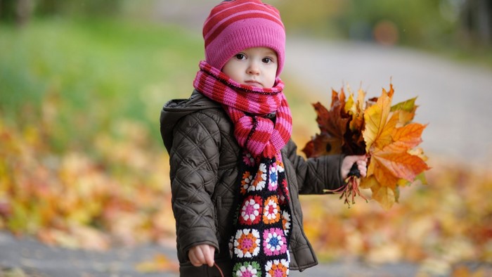 Cute baby in autumn with leaves