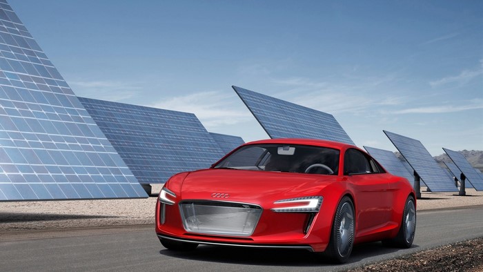 Red Audi E Tron concept car near solar panels