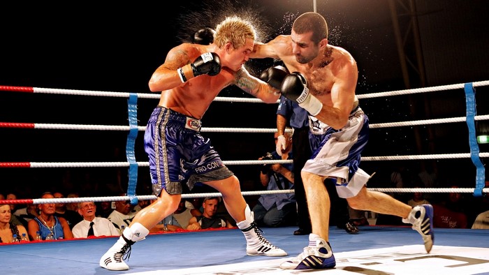 Two boxers fighting in a ring