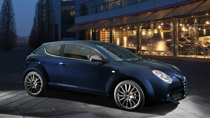 Alfa Romeo Mito parked in front of a modern building