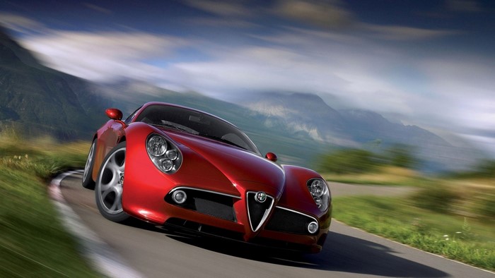 Red Alfa Romeo 8C Competizione on a mountain road