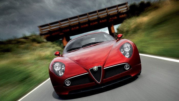 Red Alfa Romeo 8C Competizione driving on road
