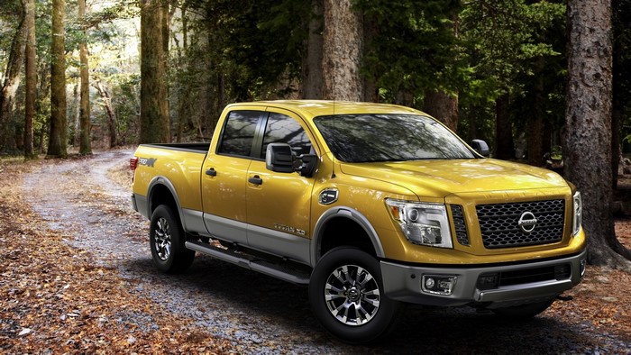 Yellow Nissan Titan XD Truck in Forest