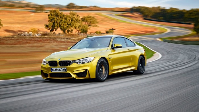 Yellow BMW M4 Coupe on a Race Track
