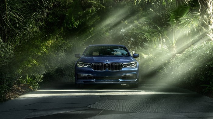 Blue BMW Alpina B7 xDrive 2017 in a forest