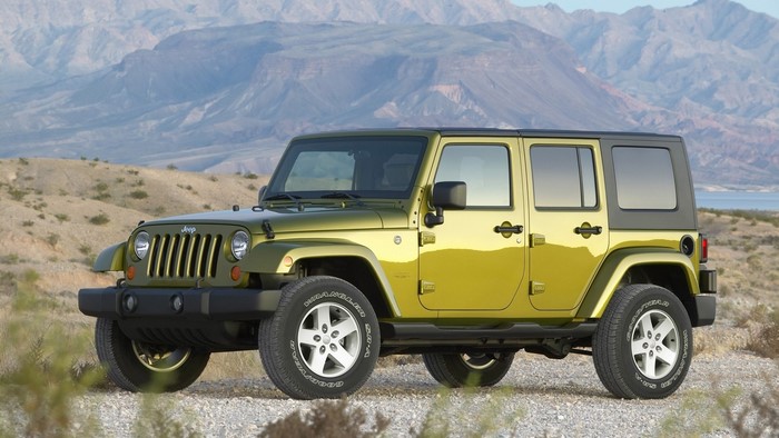 Green Jeep Wrangler Rubicon in a desert landscape