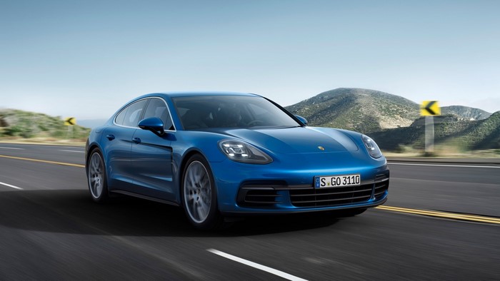 Blue Porsche Panamera driving on a road