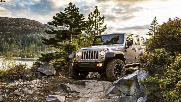 Silver Jeep Rubicon on rocky terrain