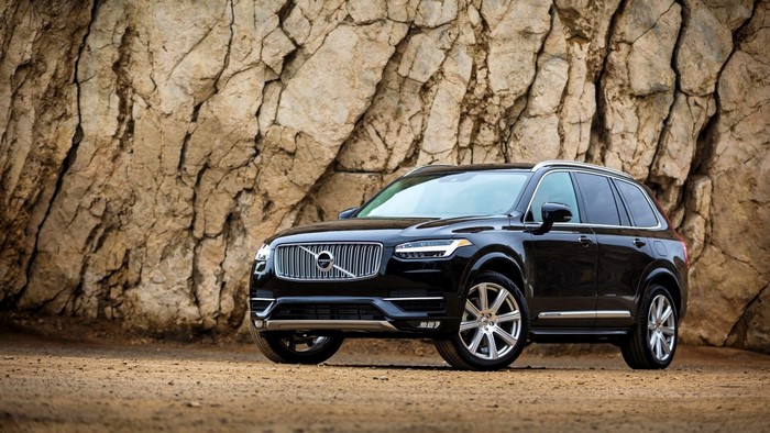 Black Volvo XC90 SUV parked on dirt road