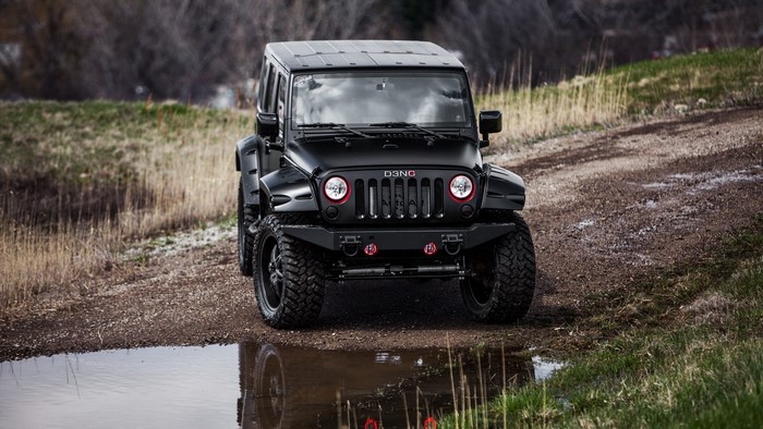 Black Jeep Wrangler on a dirt road