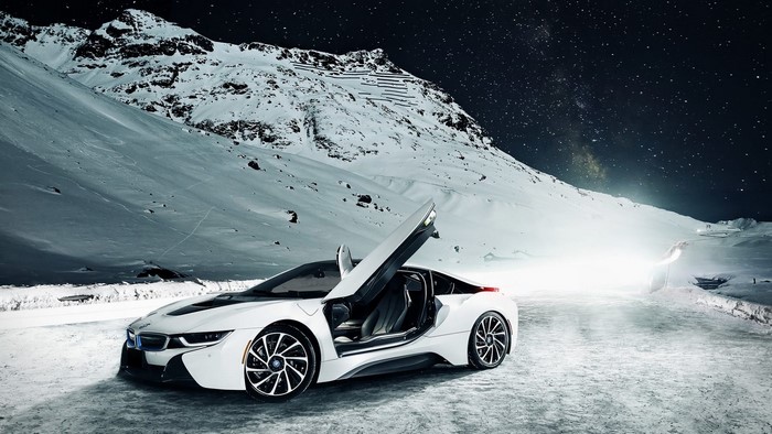 White BMW i8 sports car in snowy mountains at night
