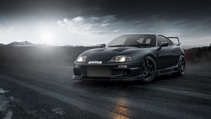 Black Toyota Supra on a misty road