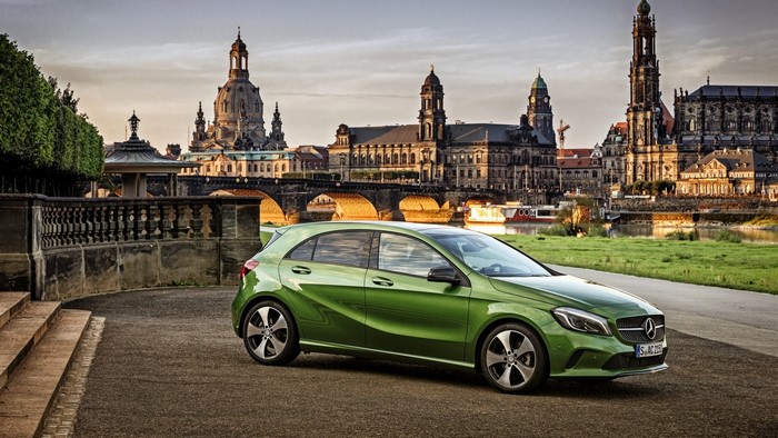 Green Mercedes-Benz A200 in front of Dresden cityscape