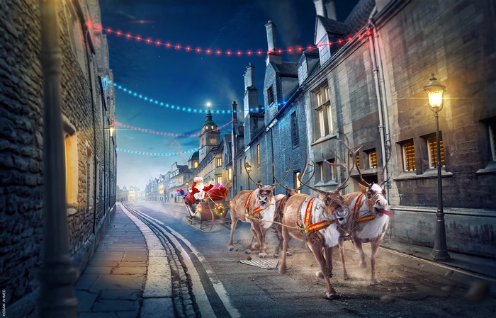 Santa Claus and reindeer chariot on a street at night