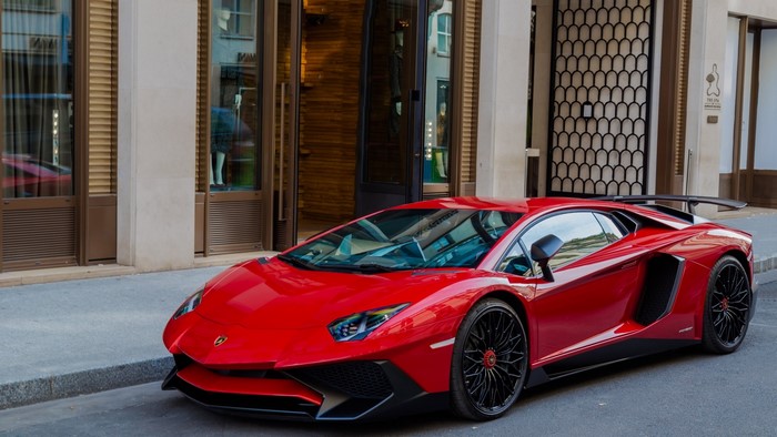 Red Lamborghini Aventador parked on street