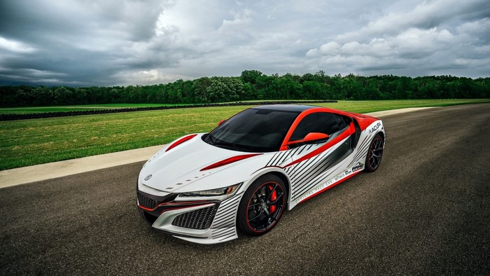 White and red Acura NSX pace car on a racetrack