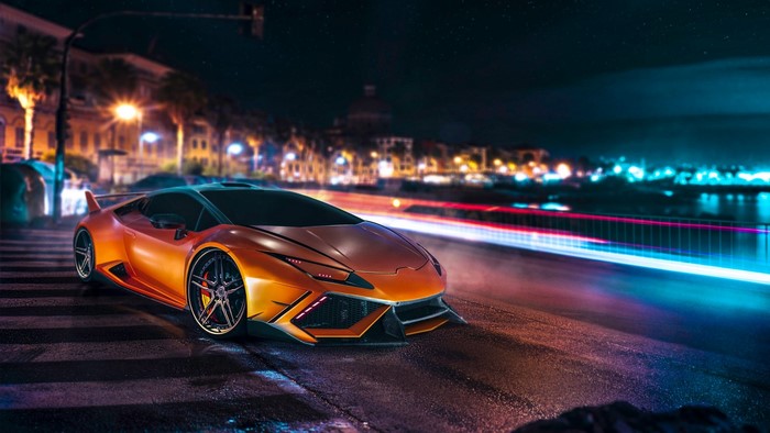 Orange Lamborghini Huracan Lp 610 4 on a city street at night