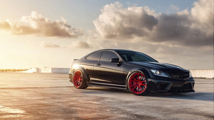 Black Mercedes Benz C63 AMG with red wheels