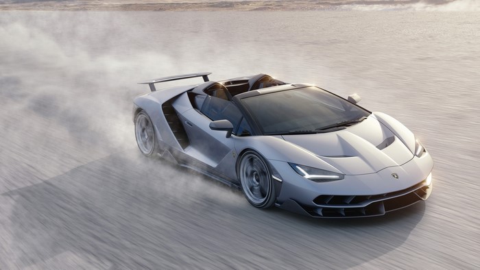 Lamborghini Centenario Roadster driving on a dusty plain