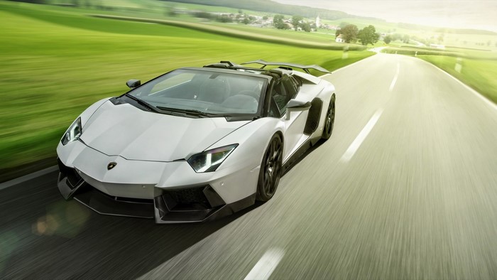 White Lamborghini Aventador Roadster Novitec Torado driving on a road