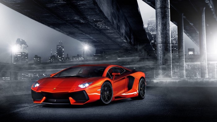 Orange Lamborghini Aventador under a bridge