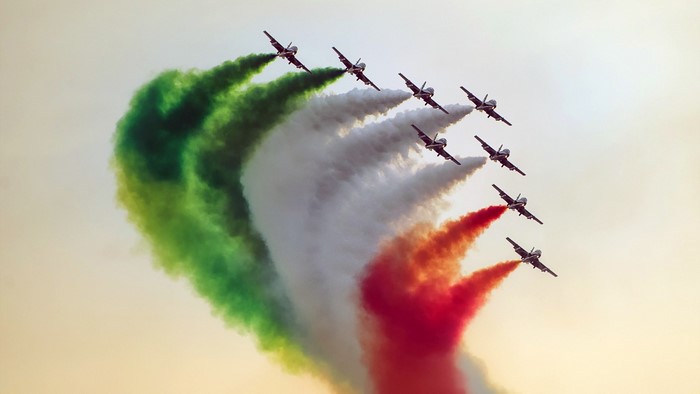 Frecce Tricolori jets flying in formation with colored smoke