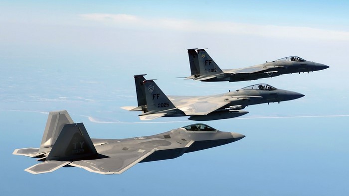 Three military fighter jets flying in formation