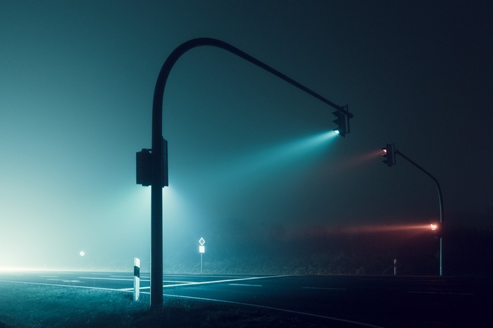 Traffic lights on a foggy night road