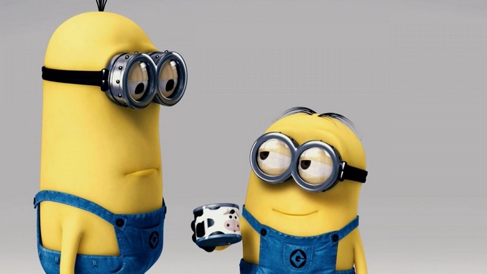 Minions from Despicable Me holding a cow-patterned cup