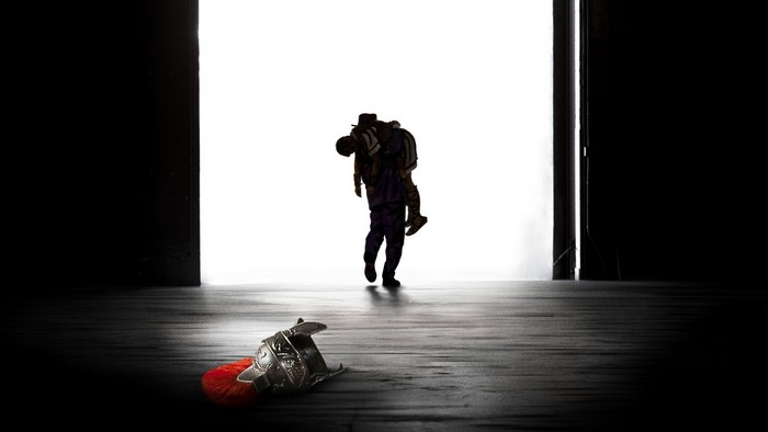 Man carrying another person from Hail Caesar movie