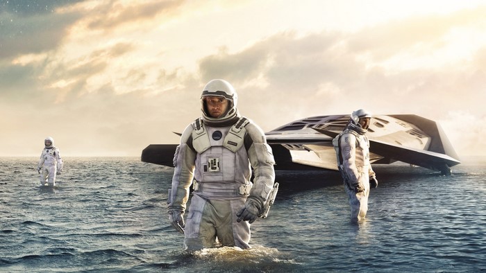 Astronauts from Interstellar movie standing in water near a spacecraft