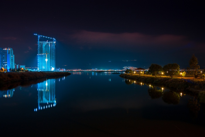 Night cityscape with construction and reflections in İzmir