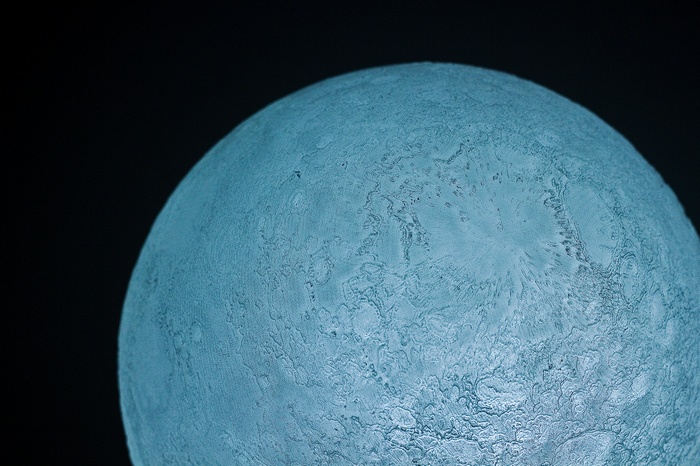 Close-up of a textured blue sphere resembling the Moon