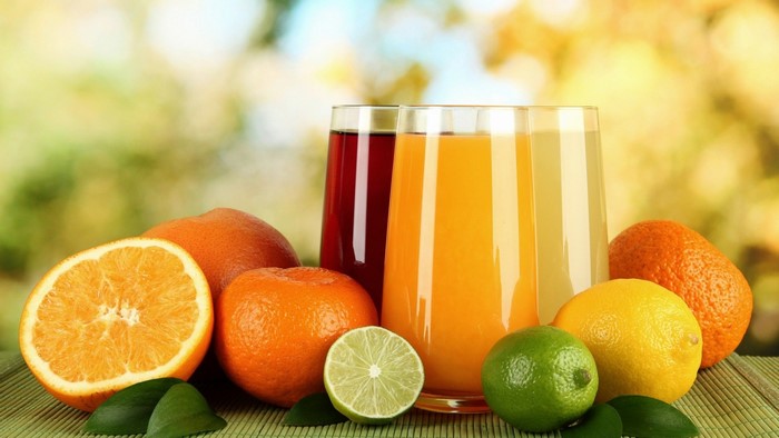 Assortment of Fresh Citrus Fruits and Juices