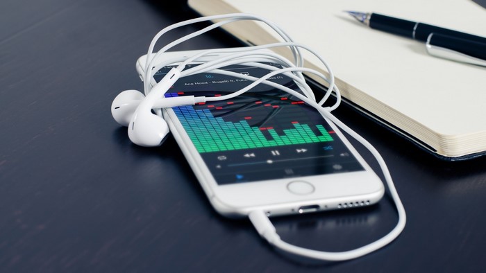iPhone 6 with headphones and notebook