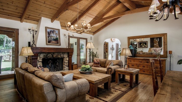 Rustic living room with stone fireplace and wooden beams