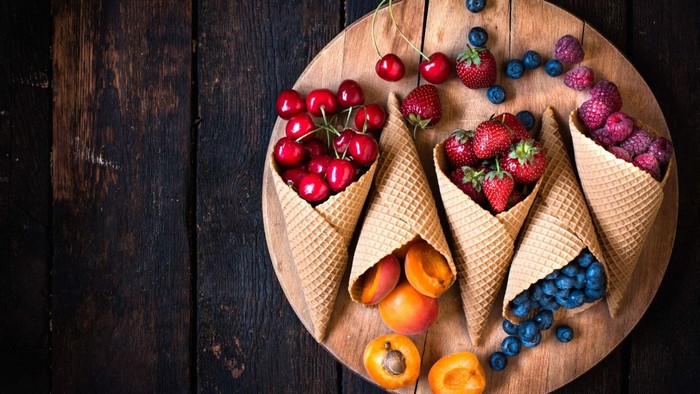 Ice cream cones filled with fresh berries and fruits